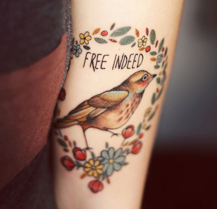 Colorful bird hand tattoo