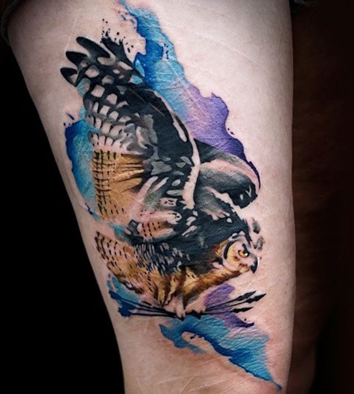 Colorful arm bird tattoo 