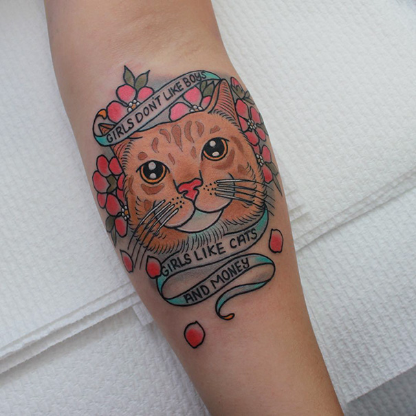 Colorful brown cat with flowers arm tattoo