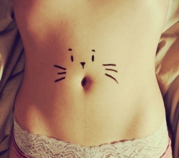 Cat face stomach tattoo