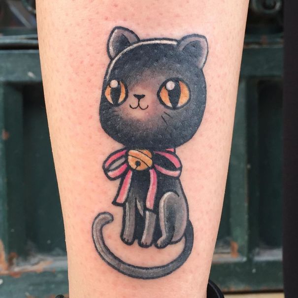 Colorful black cat with brown eyes leg tattoo