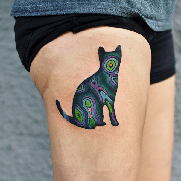 Colorful cat leg tattoo