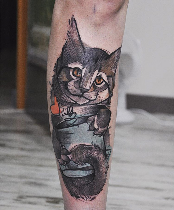 Colorful cat above knee tattoo