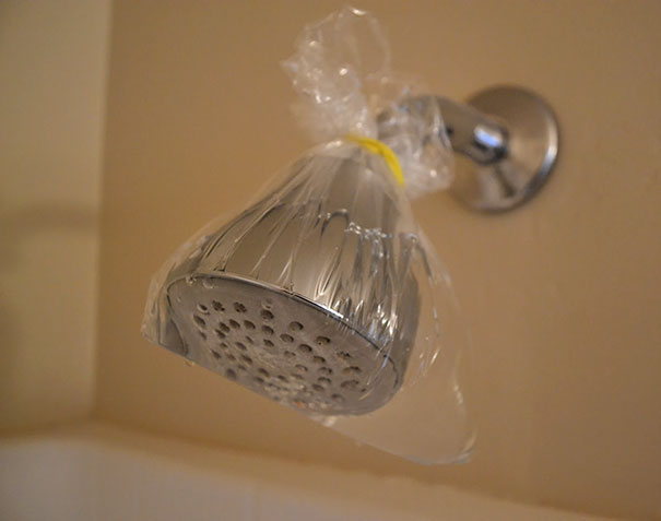 Tie A Bag Of Vinegar Around A Shower Head, Leave It There Over Night, And It Will Clean Everything Off With No Work