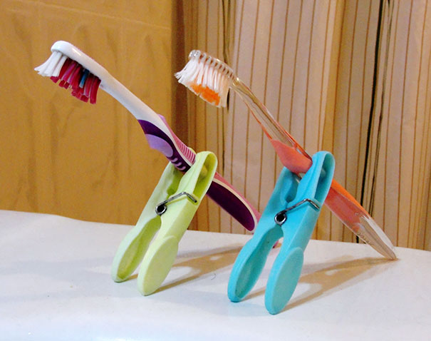 Use Clothes Pins To Prevent Your Toothbrush From Touching Dirty Counters While Travelling