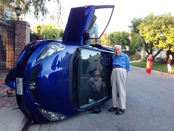Making The Best Out Of A Bad Situation: Elderly Couple Pose For Photo After Their Car Flipped (Wife Still Trapped Inside)