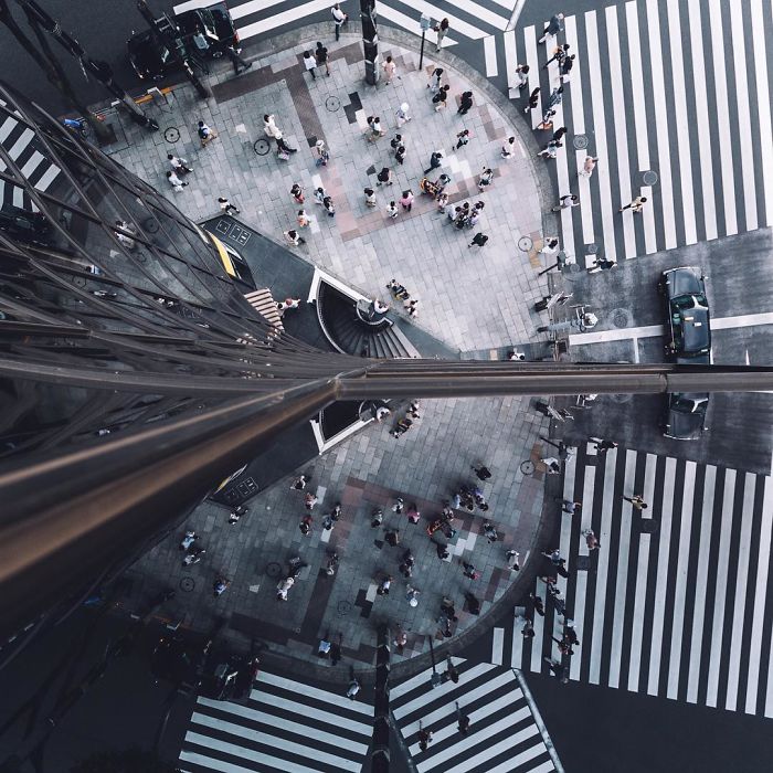 Overhead view of a busy Tokyo street intersection with pedestrians and crosswalks in Japan street photography.