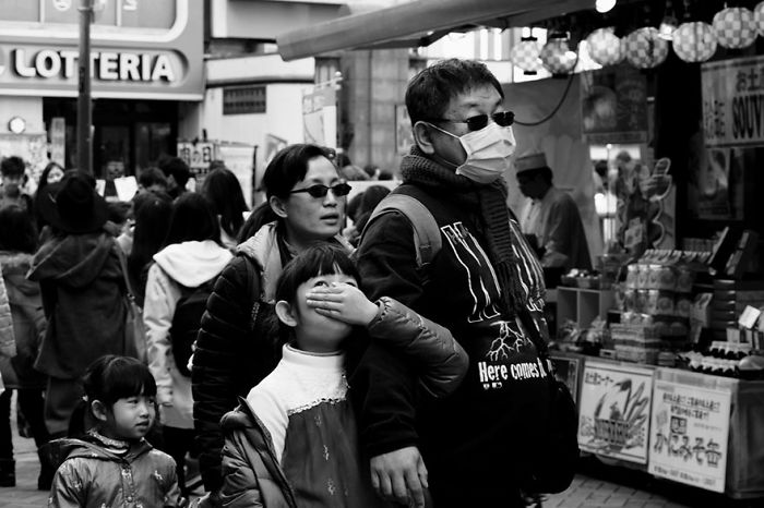 Crowded Japan street scene featuring families and shoppers, capturing authentic moments of Japan street photography.