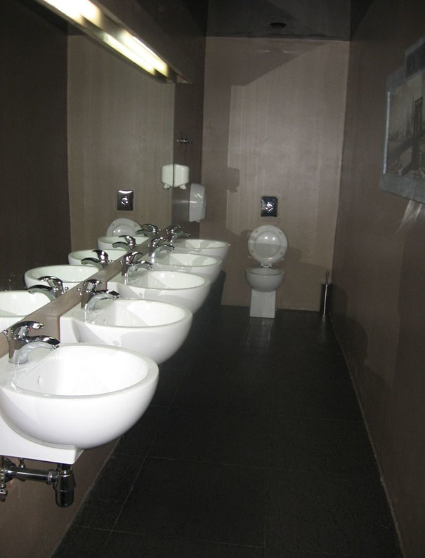 Toilet without doors near the sinks