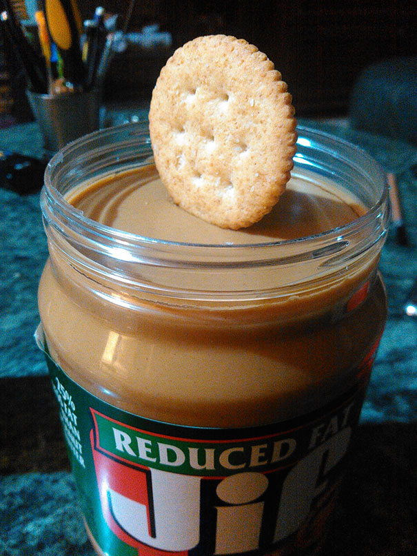 This Cracker Balancing On A Fresh Jar Of Peanut Butter