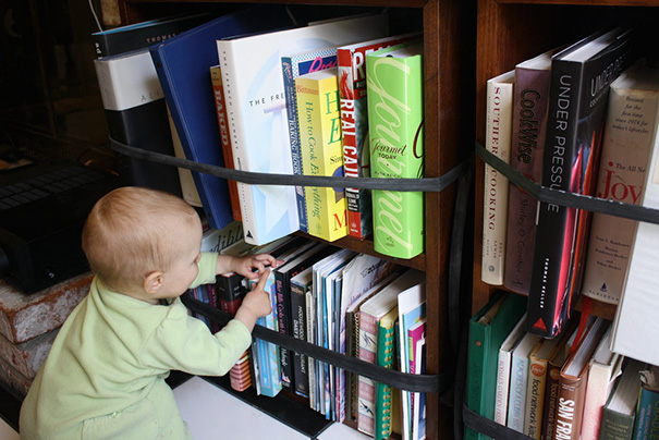 Use Bicycle Inner Tubes Tied Around Each Shelf So Your Baby Can't Access The Books