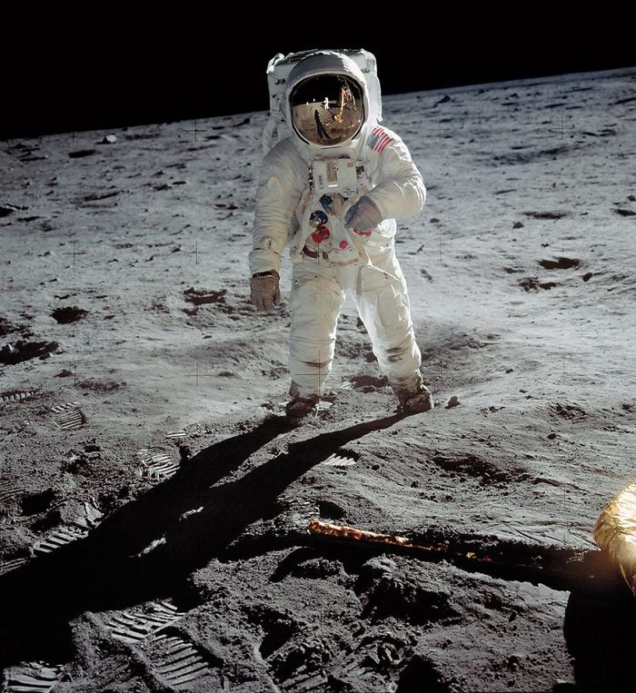 Astronaut in space suit stands on the moon's surface, one of the most famous photos in history.