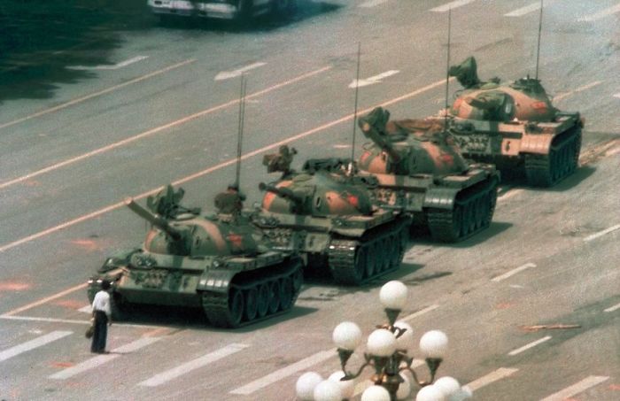 Man standing in front of tanks on a city street, one of the most famous photos in history.