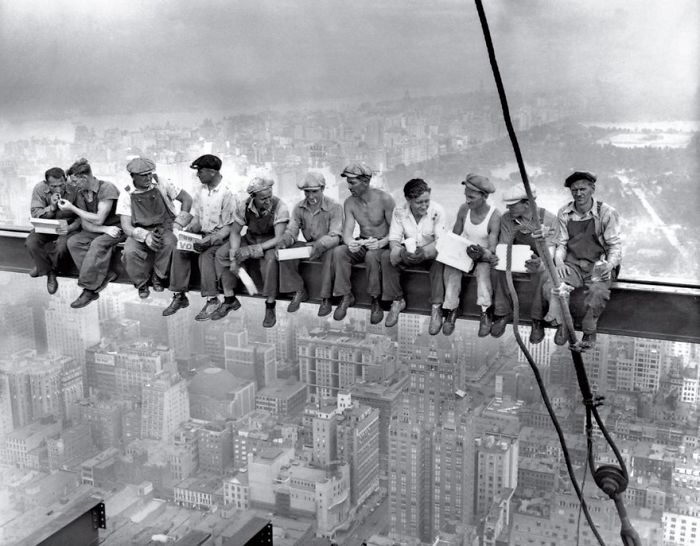 Workers having lunch on a steel beam high above a city, capturing one of history's most famous photos.