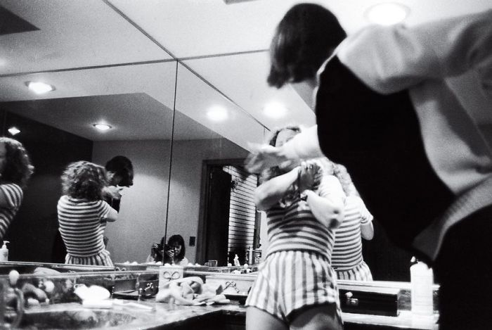 A person in striped clothing reflected in a mirror during a tense moment, capturing one of history's famous photos.