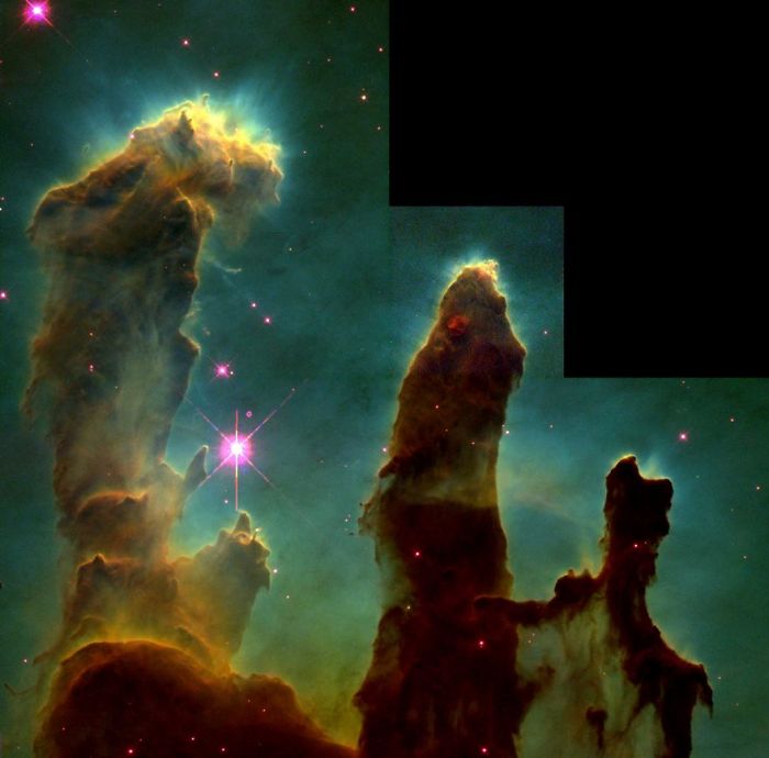 "Famous photo of the Pillars of Creation in space, showcasing towering gas formations in vibrant colors."