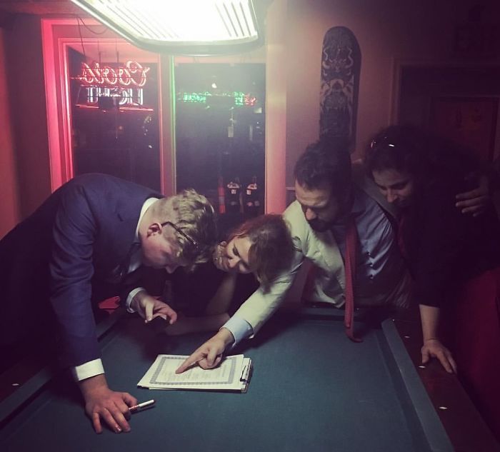Signing Their Wedding License In A Bar