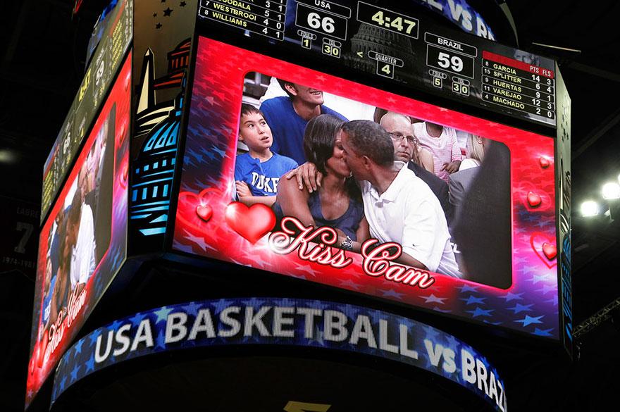 President Barack Obama And First Lady Michelle Obama Are Shown Kissing On The Kiss Cam Screen During A Timeout In The Olympic Basketball Exhibition Game Between The U.S. And Brazil National Men’s Teams In Washington On July 16, 2012