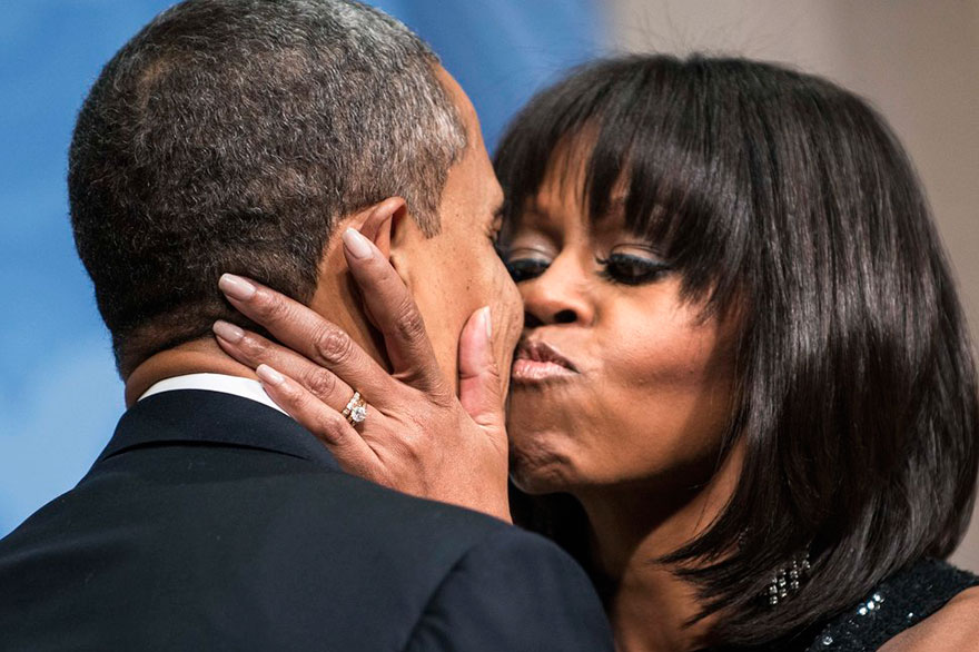 President Barack Obama Is Kissed By First Lady Michelle Obama During An Inauguration Reception At The National Building Museum On Jan. 20, 2013 In Washington, DC