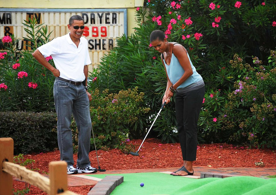 President Barack Obama Watches As First Lady Michelle Obama Putts During A Round Of Mini Golf At Pirate’s Island Golf On Aug. 14, 2010 In Panama City Beach, Florida