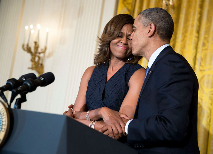 President Barack Obama Kisses First Lady Michelle Obama During Her Remarks At An Affordable Care Act Reception In The East Room Of The White House On May 1, 2014