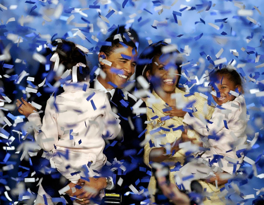Barack Obama, Holding His Daughter Malia, 6, And His Wife Michelle, Holding Their Daughter Sasha, 3, Are Covered In Confetti After Obama Delivered His Acceptance Speech In Chicago, Nov. 2, 2004