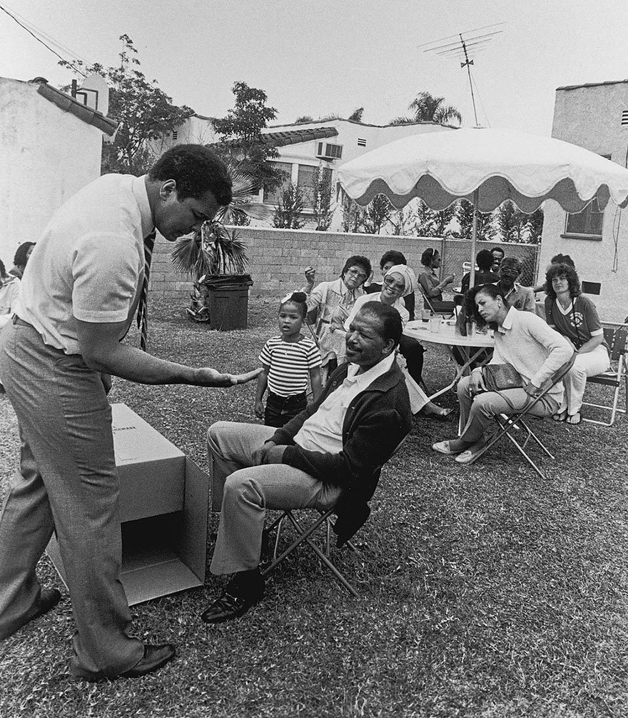 Muhammad Ali Shows Guests, Including Sugar Ray Robinson, A Magic Trick During An Outdoor Party At The Los Angeles Home Of Trainer Drew Bundini Brown In 1981