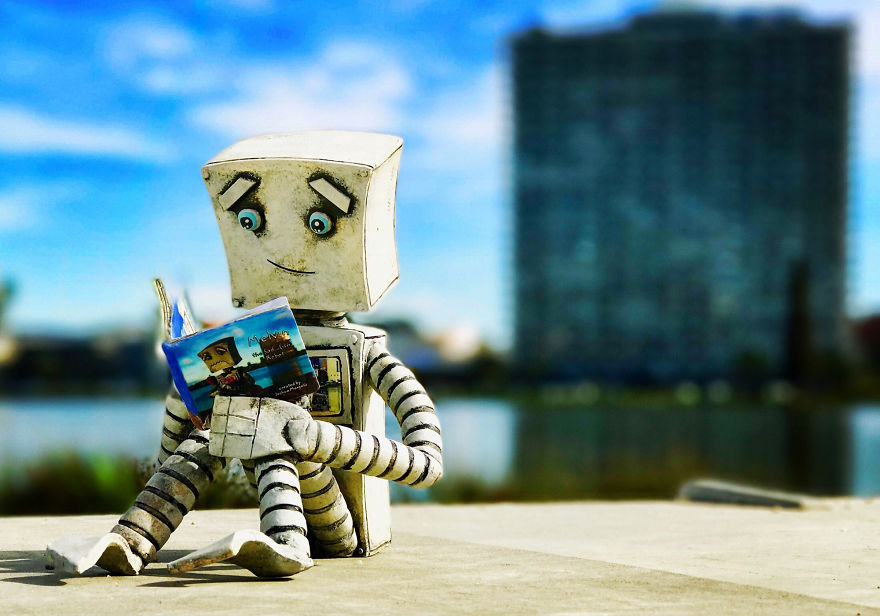 I Photographed My Clay Robot Melvin, Reading A Copy Of His New Book, Melvin The Sad...(ish) Robot