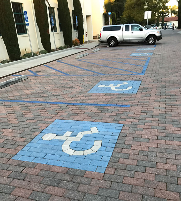colored bricks in the shape of the handicap logo on the ground