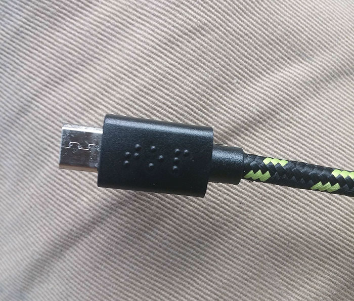 usb cord with spells in braille