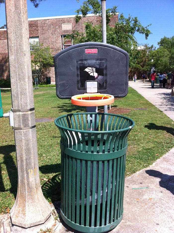 trash can with basketball basket over it