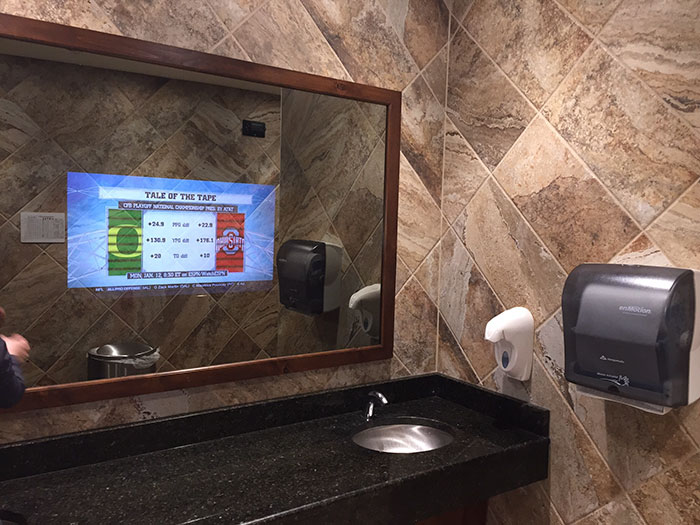bathroom mirror with a TV in it