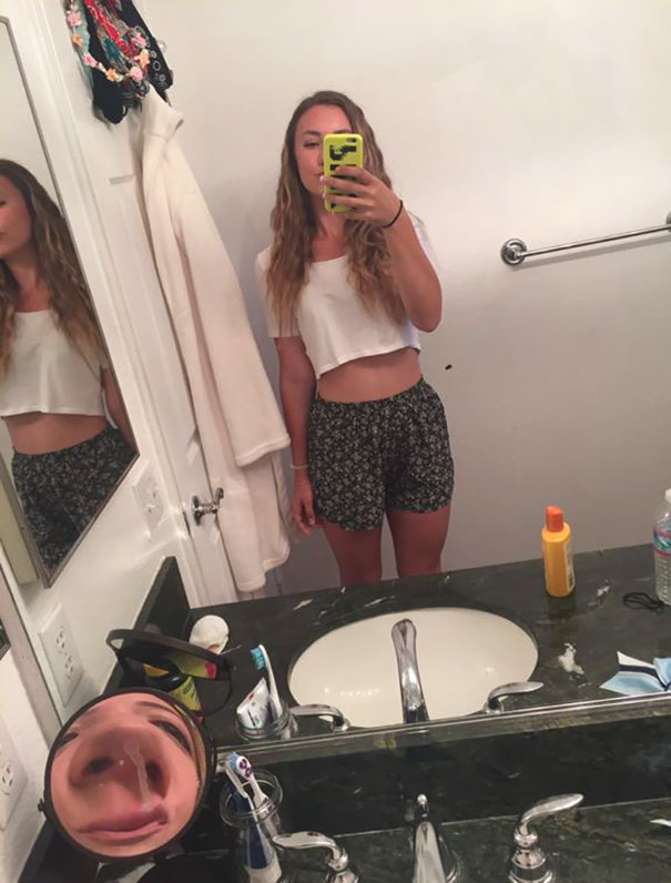 Woman taking mirror selfie 