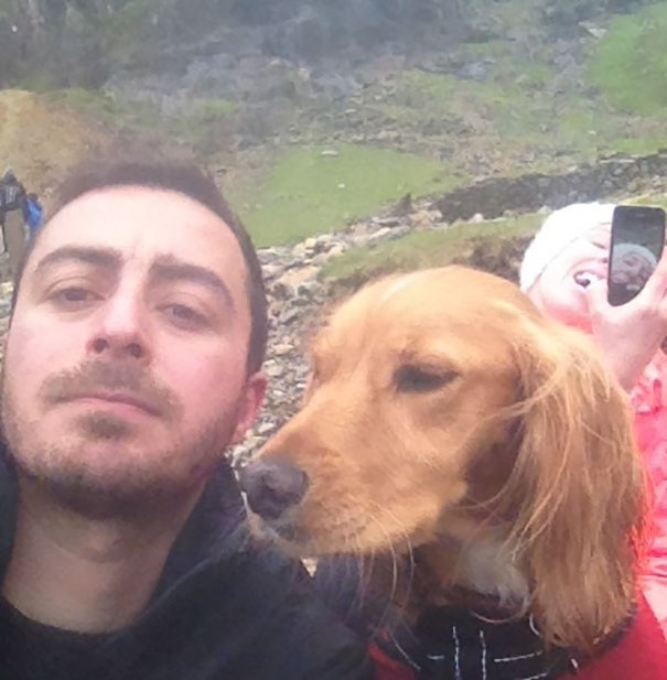 Man taking a selfie with the dog 