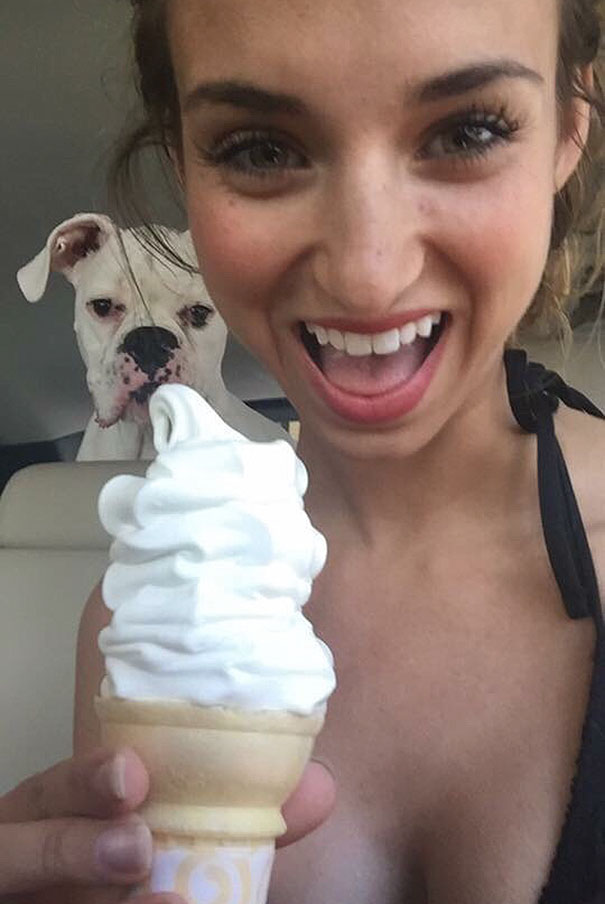 Woman taking selfie with dog and ice cream 
