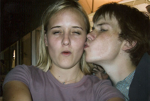 Boy kissing a girl while taking selfie 