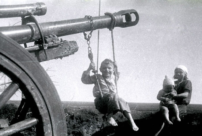 Russian Child Plays On Homemade Swing Made On A German Cannon Left Behind, 1944