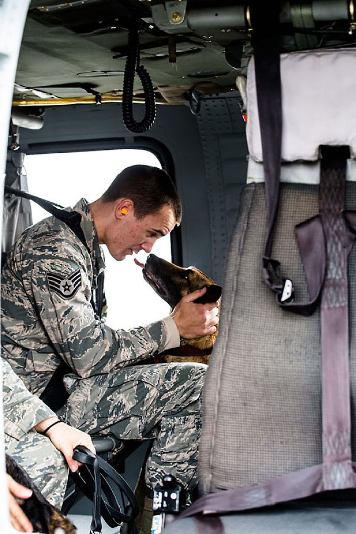 Tech Sgt. Andrew Montgomery Comforts His Dog Diesel Inside An Army UH-60 Black Hawk Helicopter