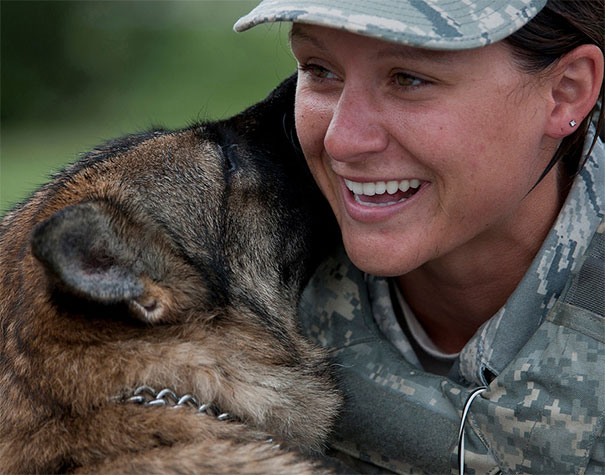 A Military Working Dog Plays With Staff Sgt. Stephanie Pecovsky