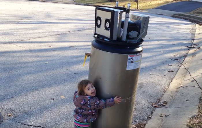 Little Girl Falls In Love With Abandoned Water Heater Thinking It’s Robot, And It’s Hilariously Adorable