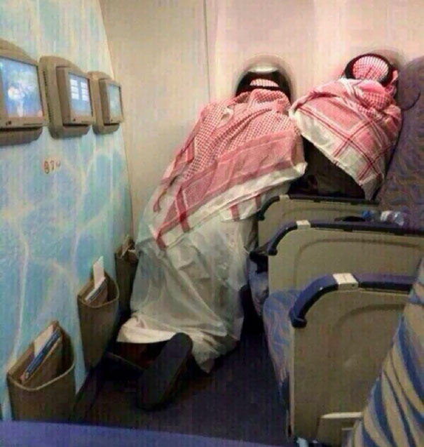 Two Saudi Old Men Peering Out The Windows Of A Plane On Their First Time Flying