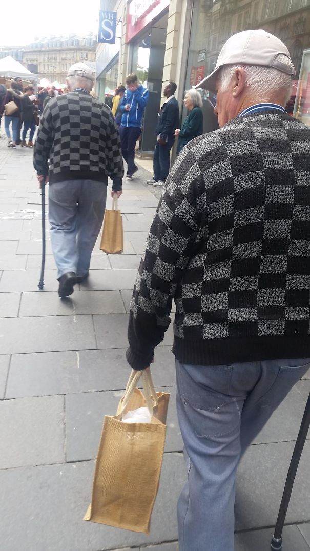 Two old man wearing same clothes walking