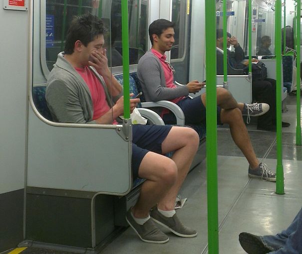 Two man sitting in the bus and wearing same clothes