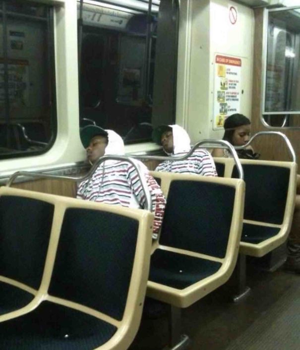 Two man sitting and sleeping in the train and wearing same clothes