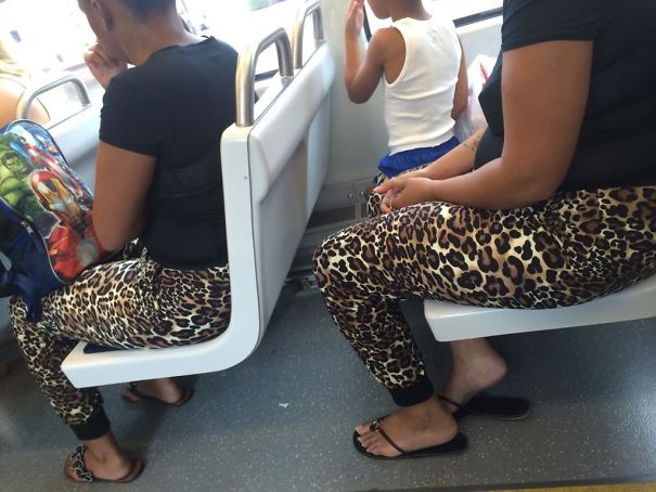 Two womens sitting in the bus and wearing similar leggings