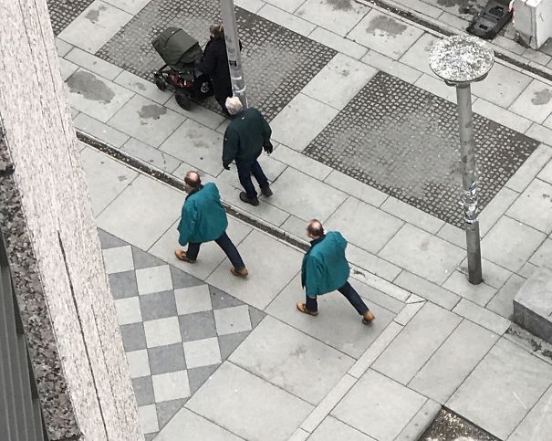 Two man walking and wearing same blue clothes