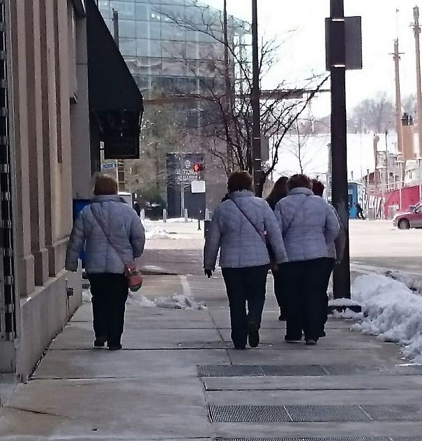 Three womans walking and wearing same jackets