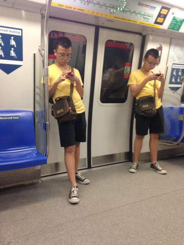 Two man wearing yellow shirts bag and black shorts looking similar