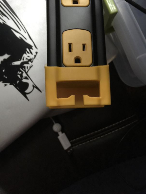 This Power Strip Outlet Looks Like A Tough Guy Trying To Flex His Muscles