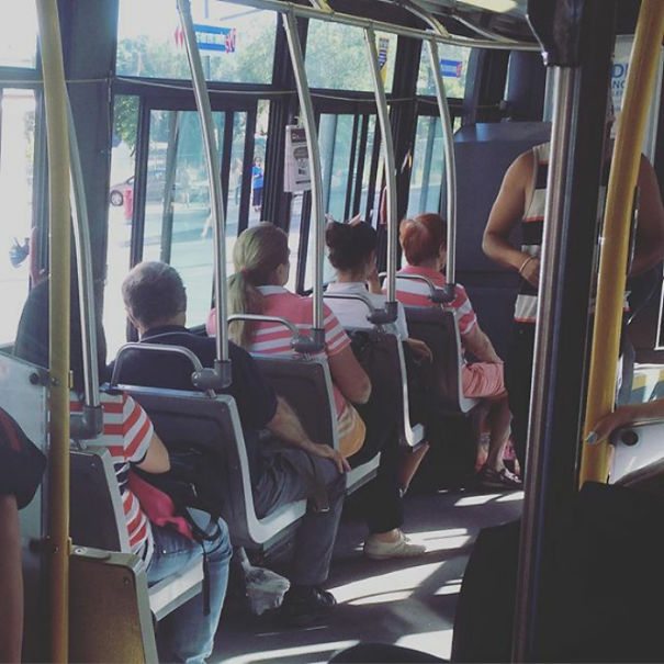 Womans sitting in the bus and wearing same clothes